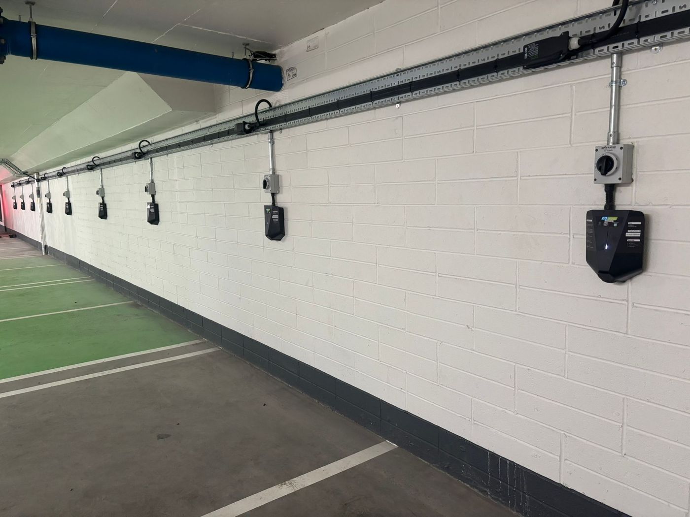 Row of EV chargers installed in a car park